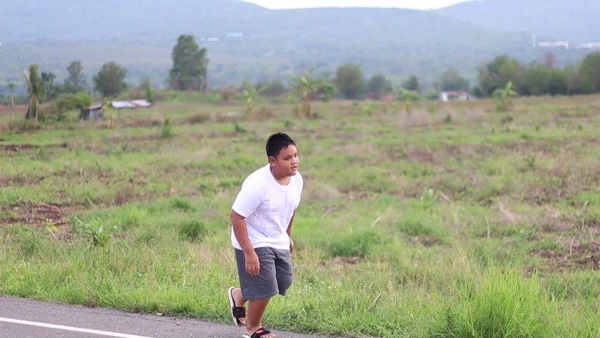 Asian boy Jogging for health Jogging as the sun approaches in the summer | Shutterstock HD Video #1071640009