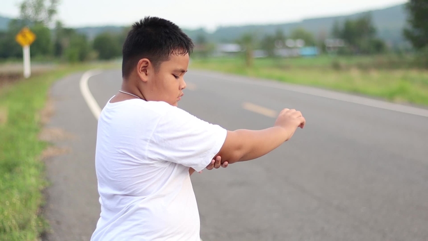 Asian boy Arm pain after exercising outdoors Jogging when the sun is about to set Exercise for health | Shutterstock HD Video #1071640177