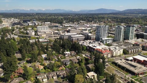 Cinematic aerial drone video of the city center, commercial district of Bellevue near Downtown Park and Bellevue Square, skyscrapers, office and apartment buildings near Seattle, Washington