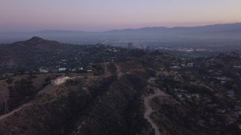 Hollywood Hills at Sunrise with view on Mountains and the valley, power lines in Los Angeles Cityscape view, Aerial Wide Angle