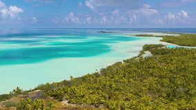 Drone video of French Polynesia Tahiti Rangiroa Fakarava atoll and Blue Lagoon and motu island with perfect beach and coral reef. Aerial footage of Tropical travel paradise in Tuamotus Islands
