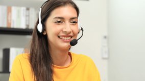 Beautiful Asian Woman making a video call smiling and talking with her friend and family to camera. Businesswoman having video call discussing, working online meeting with team at home office. 