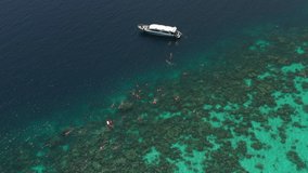Aerial footage circling around stunningly clear blue water and beautiful reefs at Bon Bay, Surin Island, Thailand. Surin Islands are considered one of the best snorkelling and freediving site