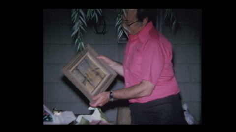 N. Belmore, New York, USA 1970: Man receives oil painting for 50th birthday present