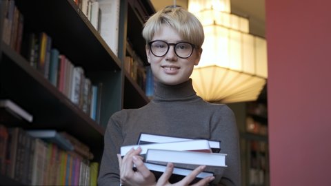 portrait of a student with books in the library