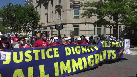 WASHINGTON, DC - MAY 1, 2021: Chanting marchers demanding the Biden administration make progress on immigration reform, head to a rally near the US Capitol. March began at Black Lives Matter Plaza.