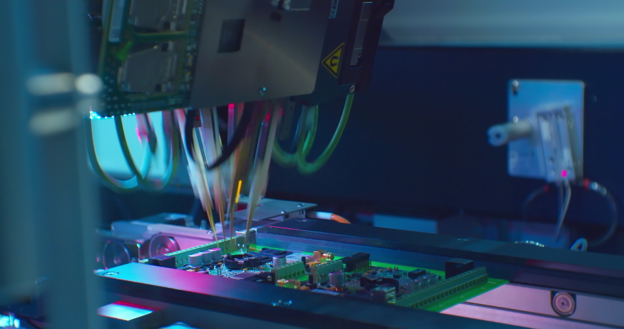 High-tech production.A modern industrial robot for electronics manufacturing makes a complex printed circuit board.Close-up. | Shutterstock HD Video #1071708901