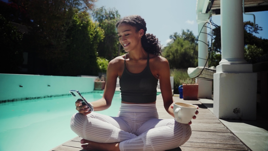 Mixed race female teen stretching outside home sitting by pool before yoga class