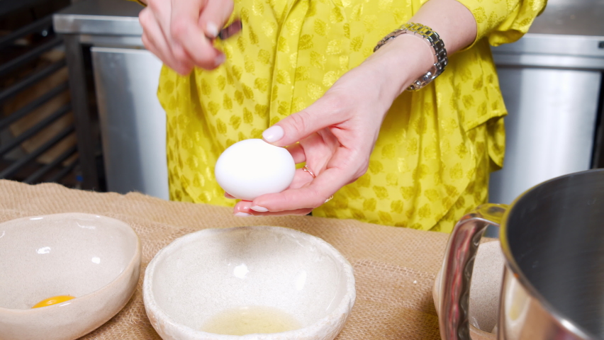 Close-up of female hands preparing dough for tasty cakes with raisins and dried fruits in kitchens. Easter holiday concept.