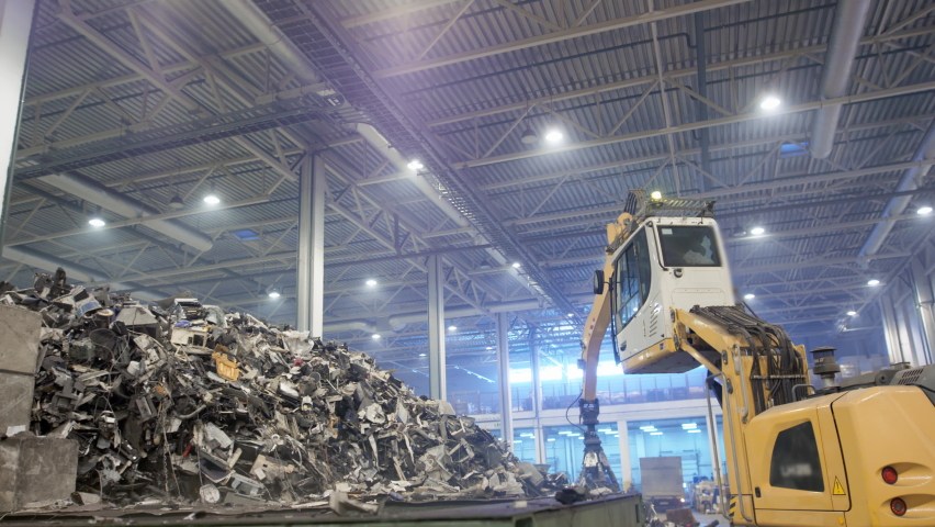 Garbage mountains. Excavator claw grabs trash on a heap in a landfill, displacing fragments of waste. Eco-friendly waste recycling. Recycling of plastic at a waste recycling plant. Waste Dump Machine | Shutterstock HD Video #1071712474