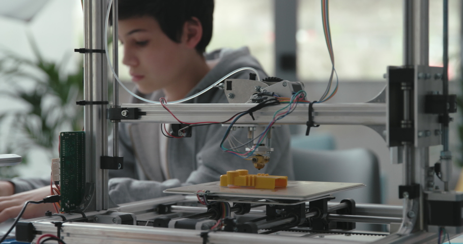 Student learning how to use a 3D printer, he is checking a 3D printed object Royalty-Free Stock Footage #1071730393