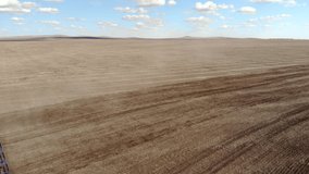 The tractor plows the field. Bird's-eye panoramic video