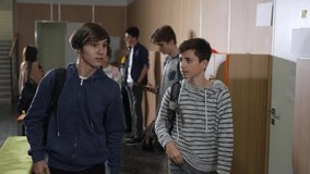 Closeup of impudent caucasian students taking tablet of african american schoolgirl standing by school locker. Shameless teen hooligans stealing digital tablet of dark-skinned classmate - Powered by Shutterstock - Get 15% off with code: PIKWIZARD15