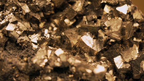 This panning video shows a macro view of a large pyrite nugget.