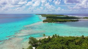 Drone aerial video of Rangiroa coral reef atoll island motu in French Polynesia, Tahiti. Amazing nature landscape with blue lagoon and Pacific Ocean. Tropical travel paradise in Tuamotus Islands