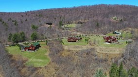 This video shows scenic aerial views of luxury homes surrounded by mountains and valleys.  
