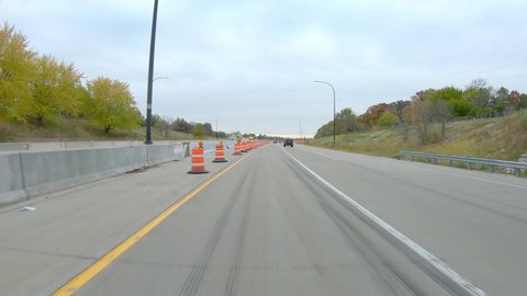 POV while driving thru a construction site on Interstate I74 near the Mississippi River in late Fall on a cloudy day in Moline Illinois