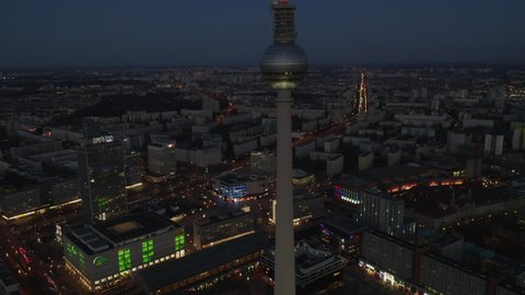 Rising up view of Berlin Germany TV Tower Alexanderplatz at Night with Cityscape and light in background, Aerial Drone Crane up Shot in 2019