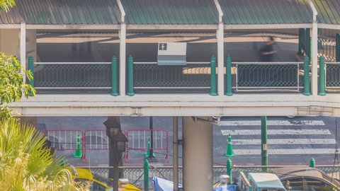 Footage 4k Timelapse of BTS Skytrain at Chidlom station in the Central business district of Bangkok people walk on the skywalk, and car traffic under overpass Sky train is main transport center CBD.