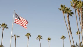 Palms and american flag, Los Angeles, California USA. Summertime aesthetic of Santa Monica Venice Beach. Star-Spangled Banner, Stars and Stripes. Atmosphere of patriotism in Hollywood. LA vibes. - Powered by Shutterstock - Get 15% off with code: PIKWIZARD15