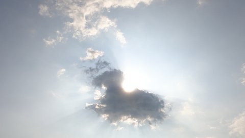 Bright sun light ray flare n bokeh sunbeam shined through white cumulus cloud n cirrocumulus cloudscape on beautiful sunny clear blue sky background in summer sunlight, 4k cinemagraph b-roll TimeLapse