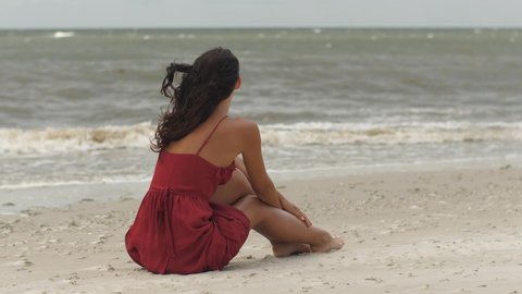Woman in a Red on the Beach, Cold Windy Weather