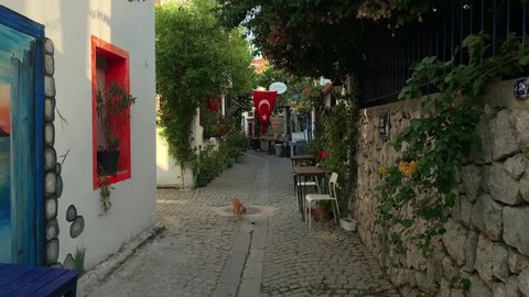 IZMIR, TURKEY - CIRCA AUGUST, 2020: Footage of narrow street, traditional, old houses, boutique hotels in famous, touristic Aegean town called "Sigacik". It is a village of Seferihisar district.