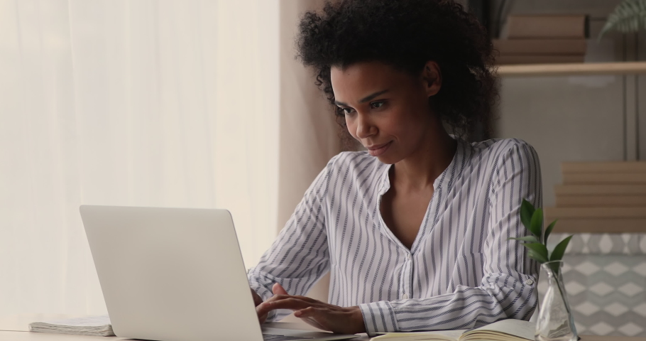 Young African businesswoman working on project typing on computer, writes answer to client remotely, search information, freelancer thinking over creative telecommute, workday at home office concept Royalty-Free Stock Footage #1071788590