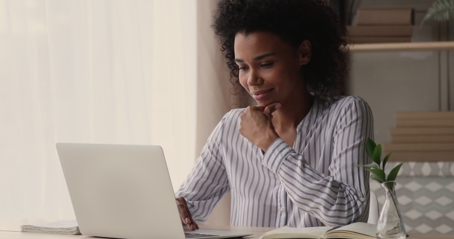 Young African businesswoman working on project typing on computer, writes answer to client remotely, search information, freelancer thinking over creative telecommute, workday at home office concept | Shutterstock HD Video #1071788590