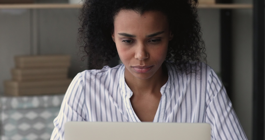 African woman working on laptop feels stressed about system virus, important data loss, outraged with website mistake, close up. Slow and stuck computer, malware, broken device, need repair concept | Shutterstock HD Video #1071788644