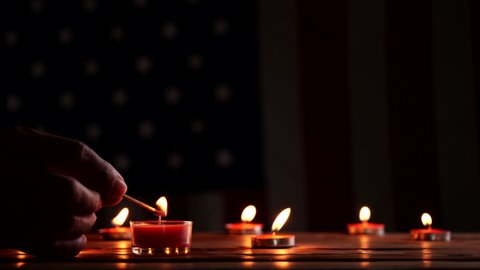 Memorial Day, Burning candle on American flag background. Concept of Memorial Day or 4th of July, Independence Day, Veterans Day, American Celebration, USA flag.