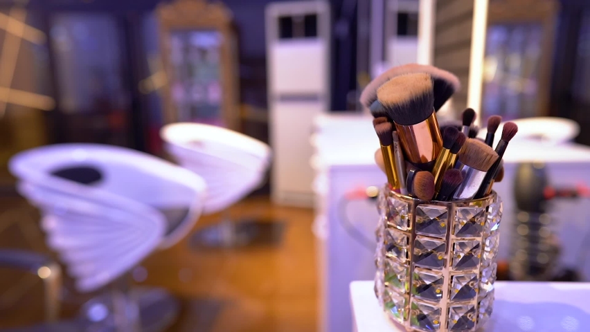 A set of brushes for makeup is on the table - slow motion 120 fps