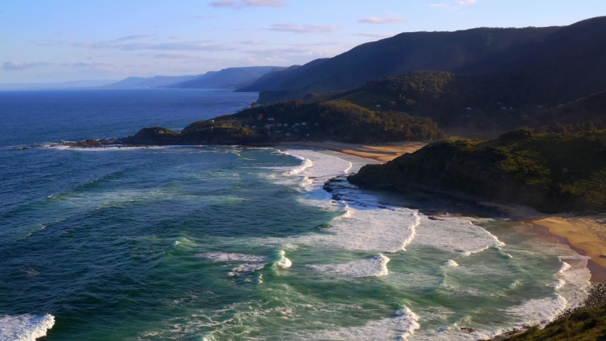 Idyllic Scenery With Ocean And Lush Hills At North Era Beach In Royal National Park, New South Wales, Australia - aerial static shot