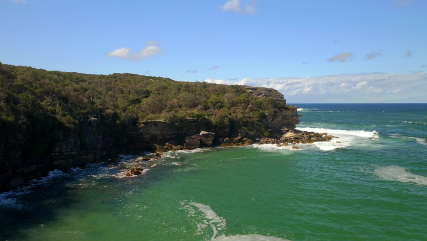 Rocky Cliff Edge With Foamy Sea Waves In Summer At Royal National Park, South Of Sydney, New South Wales, Australia. - Aerial Shot