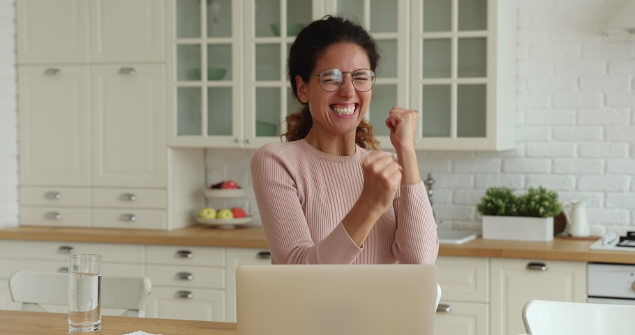 Excited happy woman sit in kitchen with laptop read email scream with joy celebrate great news feel overjoyed, got new job, special offer and discount. Gambling, on-line auction victory moment concept Royalty-Free Stock Footage #1071802846