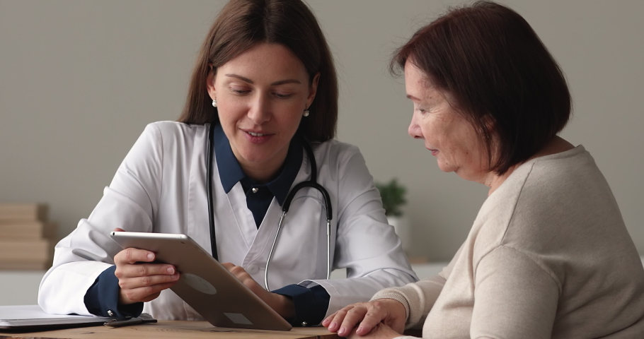 Doctor explain to older patient medical test result on tablet, use website gives recommendation about disease treatment medications show positive forecast. Medicine and modern tech usage app concept | Shutterstock HD Video #1071803008