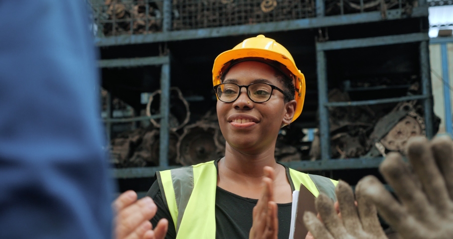 Close up of black women worker happiness in factory and engineering team, Team of factory workers celebrate a great success by putting hands together. | Shutterstock HD Video #1071803122