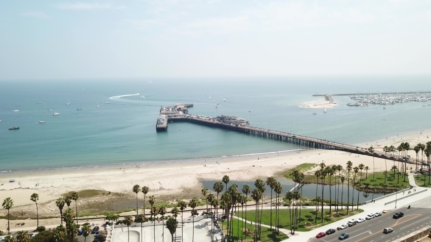 Santa Barbara pier and beach in sunny day, California. Aerial forward Royalty-Free Stock Footage #1071816439
