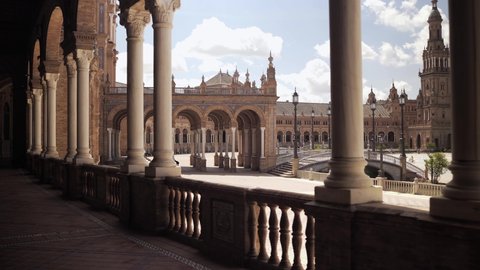 Seville, Spain - April 22, 2021: View of the exterior of the Spain square (Plaza de España) from one of its corridors full of white columns 