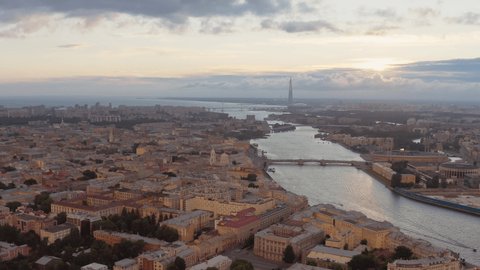 The Russian Venice, Aerial footage of center of Saint Petersburg, Russia at evening, Flight over the river and drawbridges at sunset, cityscape in dusk, skyscraper on background, 