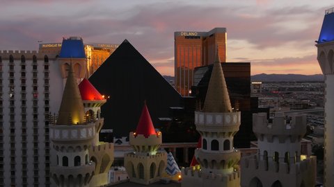 LAS VEGAS, NEVADA USA - 4 MAR 2020: Excalibur castle and Luxor pyramid casino uncommon aerial view. Plane flying from McCarran airport. Mandalay Bay and Delano hotel in american gambling sin city.