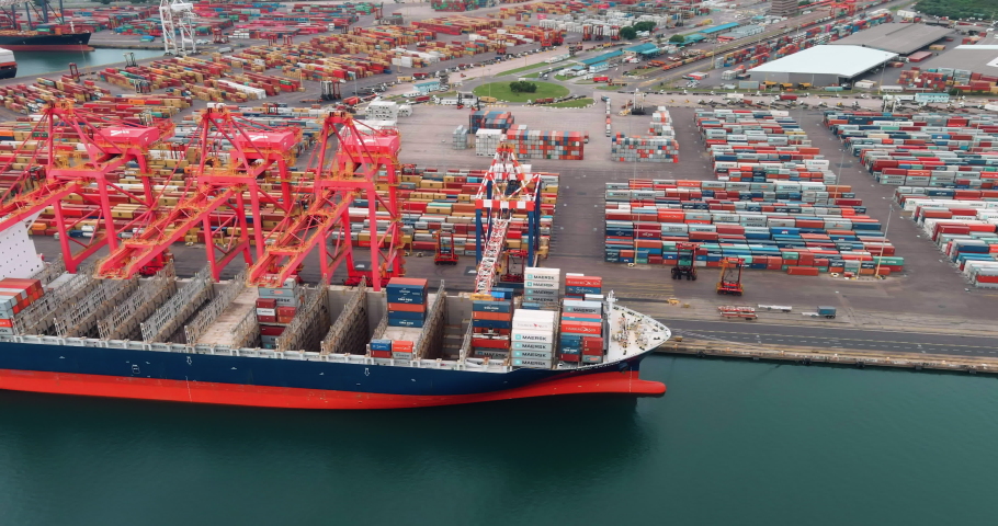Aerial view of shipping containers being loaded onto a container ship at Durban harbour, South Africa,  global supply chain,  Royalty-Free Stock Footage #1071832546