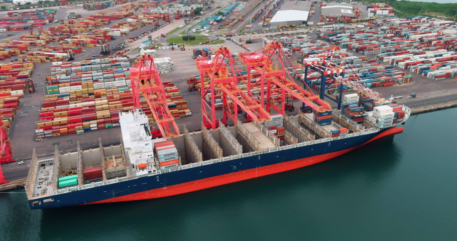 Aerial view of shipping containers being loaded onto a container ship at Durban harbour, South Africa,  global supply chain,  | Shutterstock HD Video #1071832546