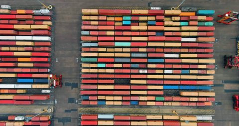 Straight down aerial view of thousands of shipping containers waiting on the docks to be loaded onto a container ship at Durban harbour, South Africa,  global supply chain, 