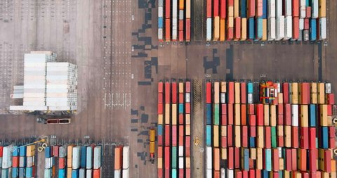 Straight down aerial view of thousands of shipping containers waiting on the docks to be loaded onto a container ship at Durban harbour, South Africa,  global supply chain, 