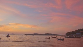 Beautiful colorful sky above fishing boats at sunrise. Nature video High quality footage time lapse day to night in nature and travel concept