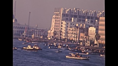 Port Said skyline in Egypt with local boats in Mediterranean sea. Historical archival of Egypt in 1980s with egyptian arab buildings. Historical archival of Egypt in 1987.
