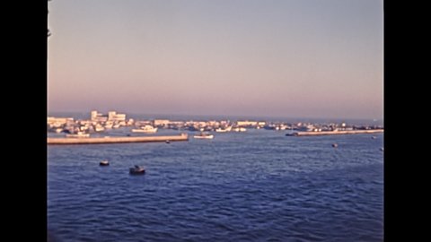 Port Said cityscape in Egypt from boat in Mediterranean sea. Historical archival of Egypt in 1980s with city lighthouse. Historical archival of Egypt in 1987.