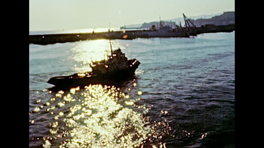 Tugboat in the city port of Genova town in 1981. Archival of Italy in the 1980s with Genova city Italian harbor.