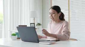 Young attractive business asian woman talking about sale report in video call conference on notebook online meeting in working from home reskill upskill, Working remotely and Social isolation concept.